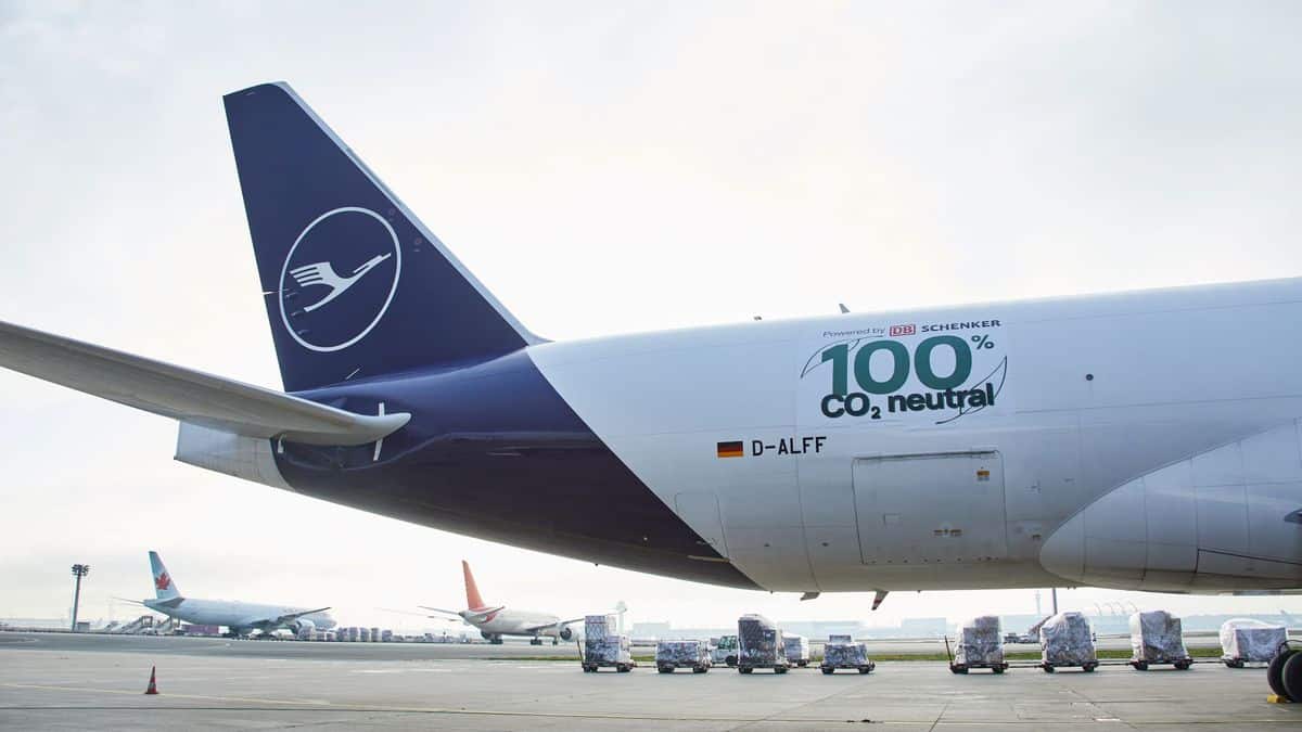 Tail end of Lufthansa jet with logo showing 100% carbon neutral flight.