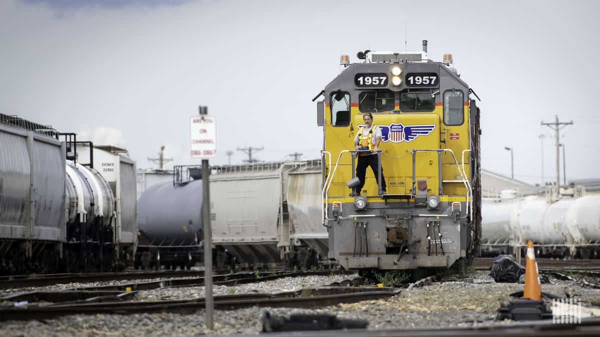 A photograph of a man stranding in front of a Union Pacific locomotive.