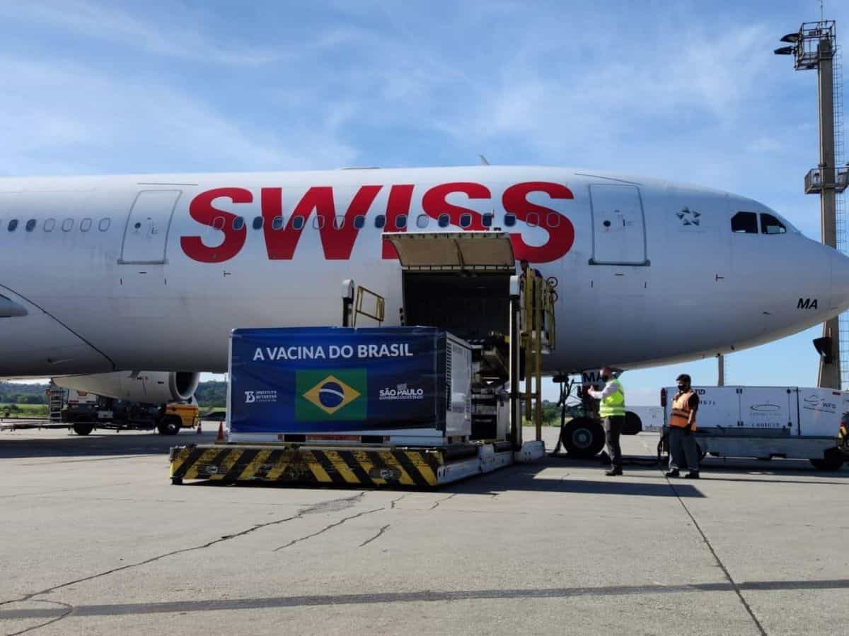 SWISS plane loaded with cargo on sunny day.