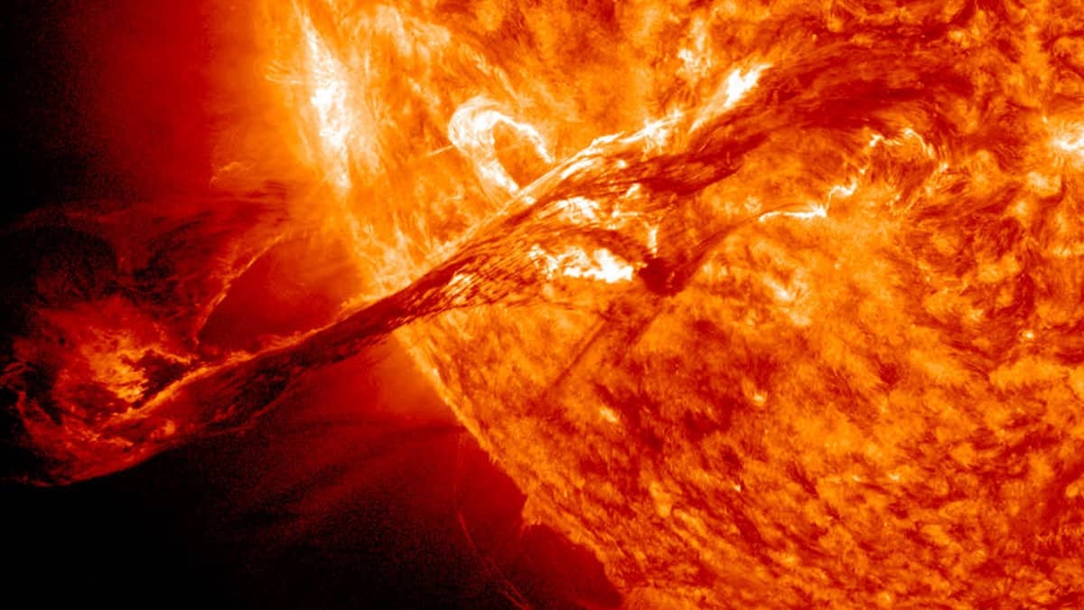 Photo of a solar flare shooting from the sun.