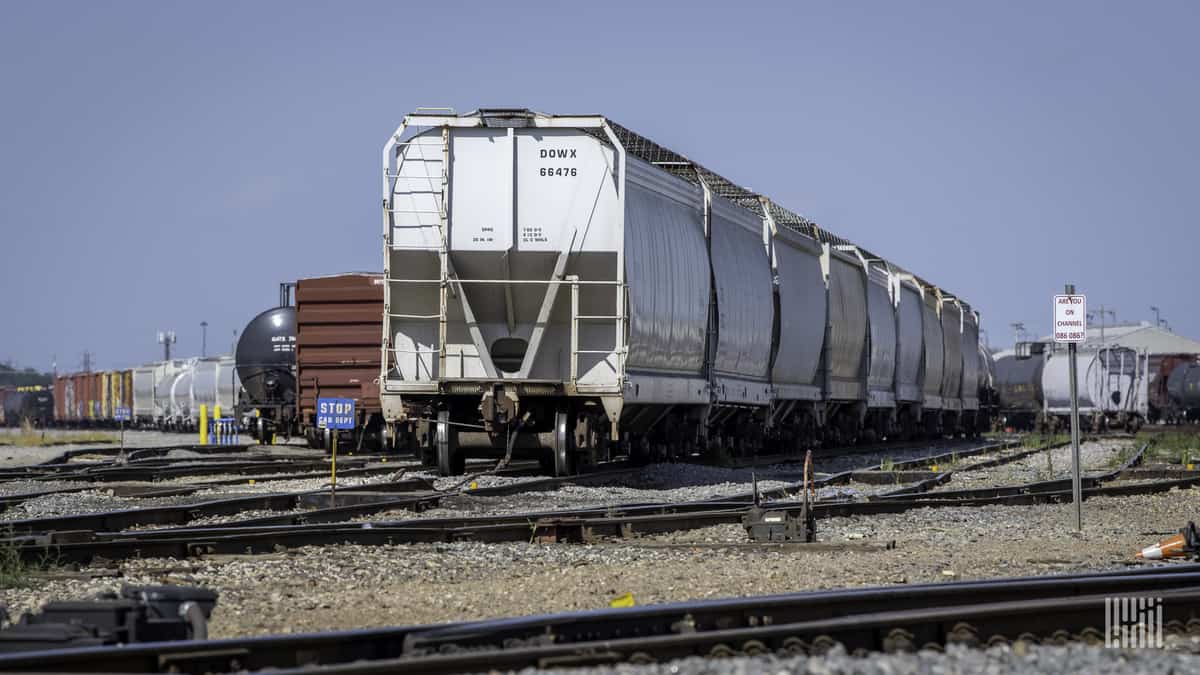 A photograph of railcars parked in a rail yard.