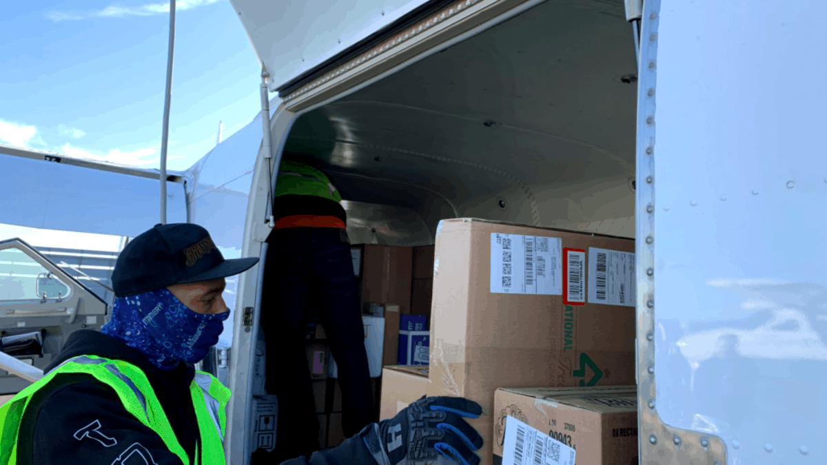 A box of vaacines loaded in the side of a single-seat turboprop plane.