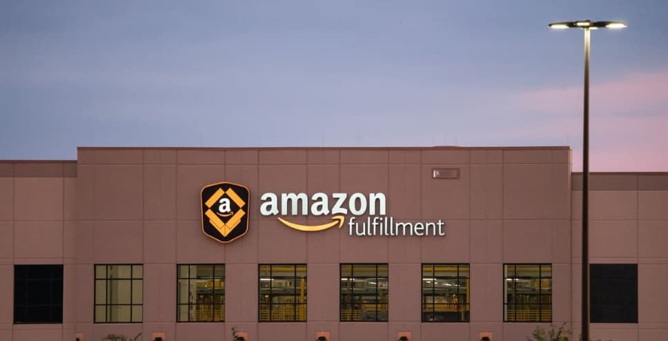 A brown Amazon warehouse with sign on front.