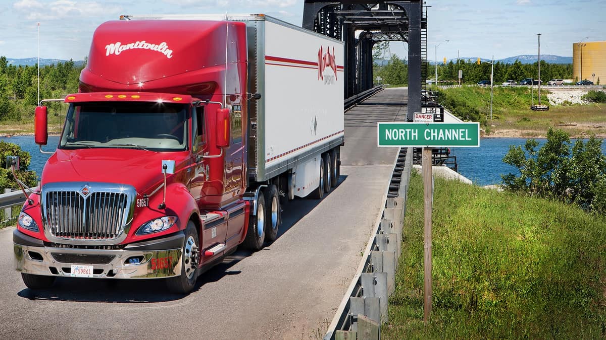 A tractor-trailer of Manitoulin Transport crossing a bridge. Manitoulin acquired a third US freight forwarder.