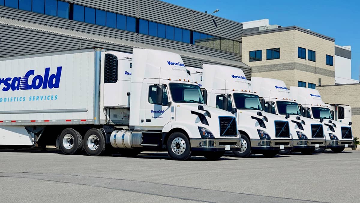 VersaCold Logistics tractor-trailers at a loading dock. TorQuest acquired VersaCola, a large Canadian cold storage provider.