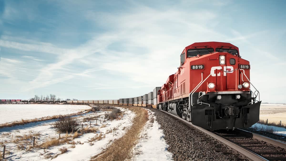 A photograph of a Canadian Pacific train traveling through a snowy field.