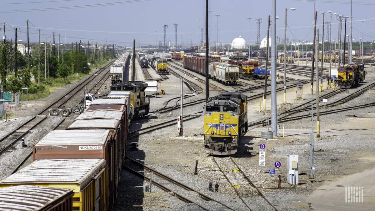 A photograph of rail cars parked in a rail yard.