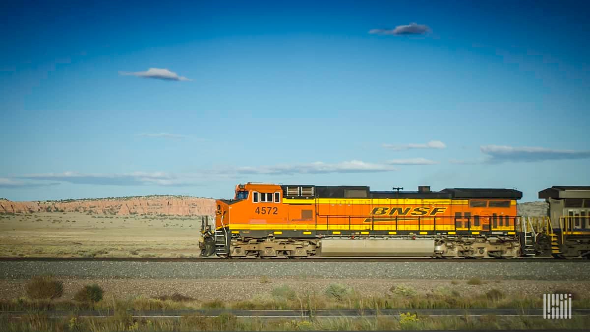 A photograph of a BNSF locomotive crossing a field.