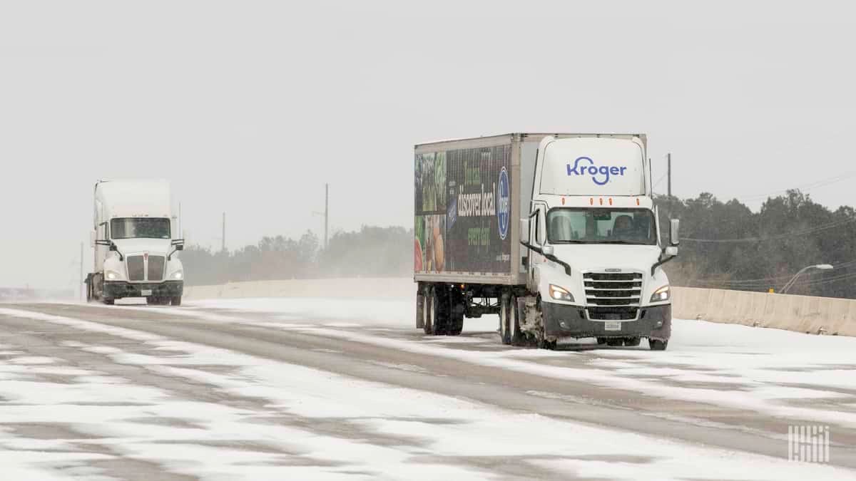 Tractor-trailers on a snow-covered Houston highway.