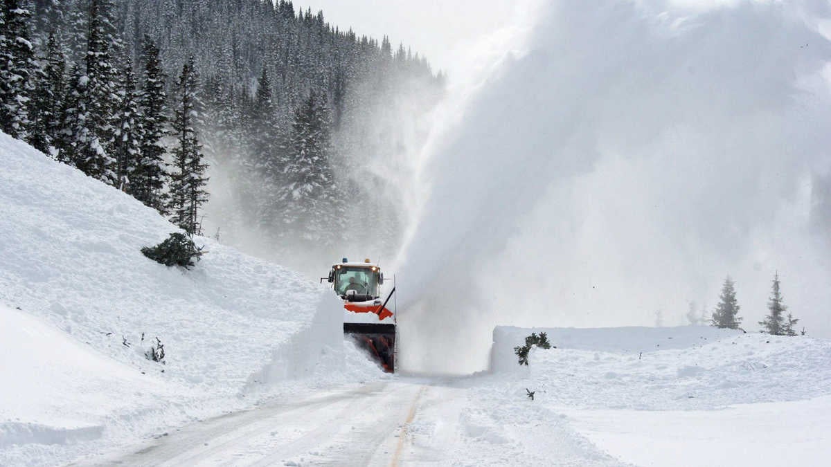 A photograph of a snow plow clearing a road.