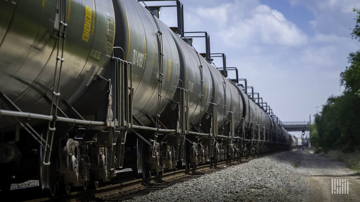 A photograph of tank cars parked in a rail yard.