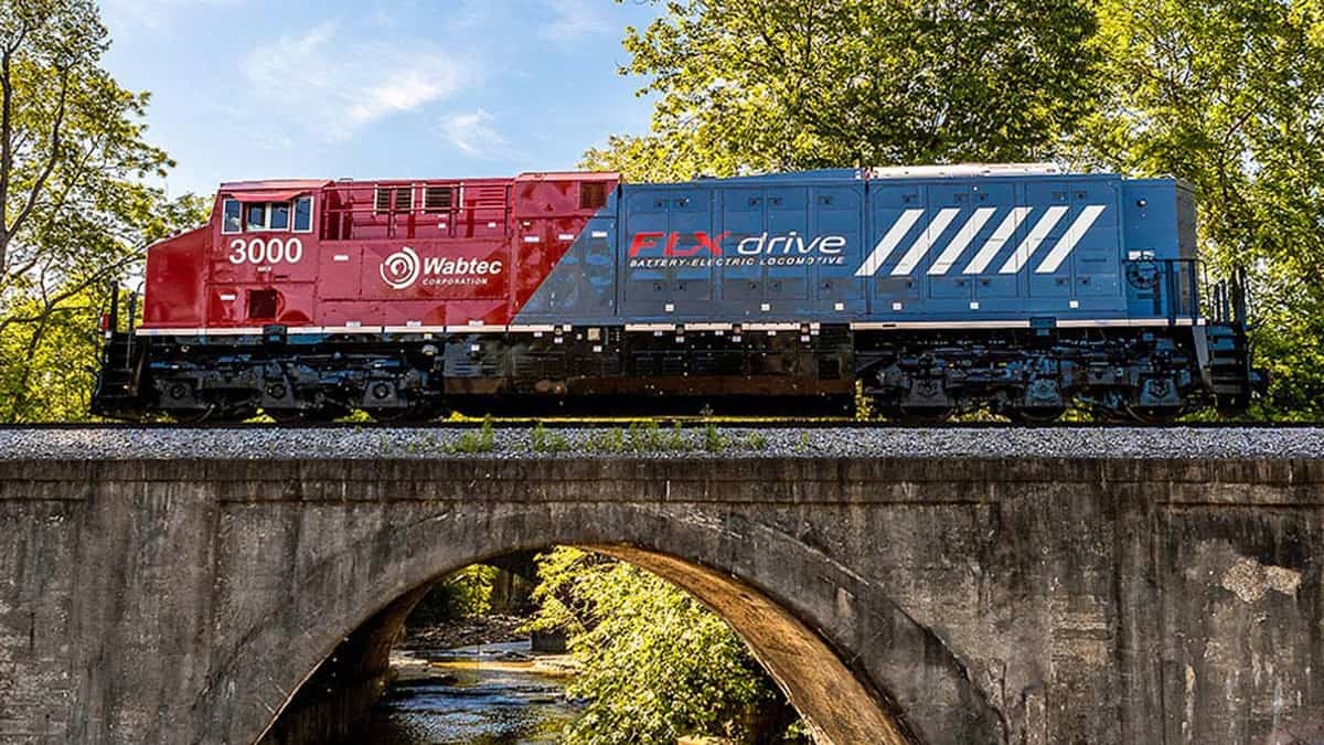 A photograph of a train locomotive crossing over a bridge.