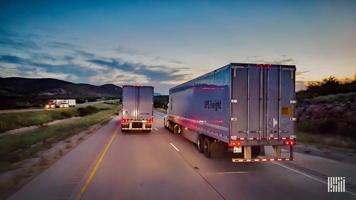 Two tractor-trailers of UPS Freight. TFI International is acquiring UPS Freight.