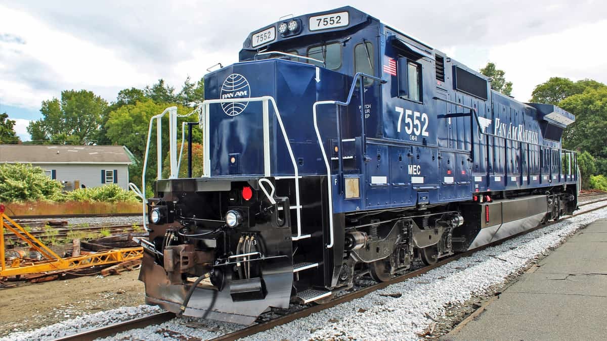 A photograph of a train locomotive at a suburban platform.