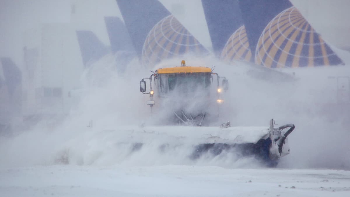 Plow trucks clearing runways at Denver International Airport.