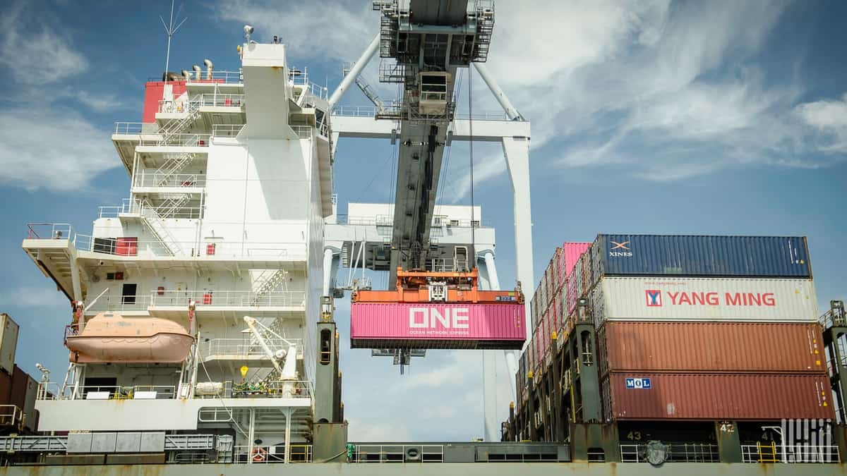 Containers being loaded onto a ship to illustrate the shipping firm ECU Worldwide being threatened with a data leak by hackers in a ransomware gang.