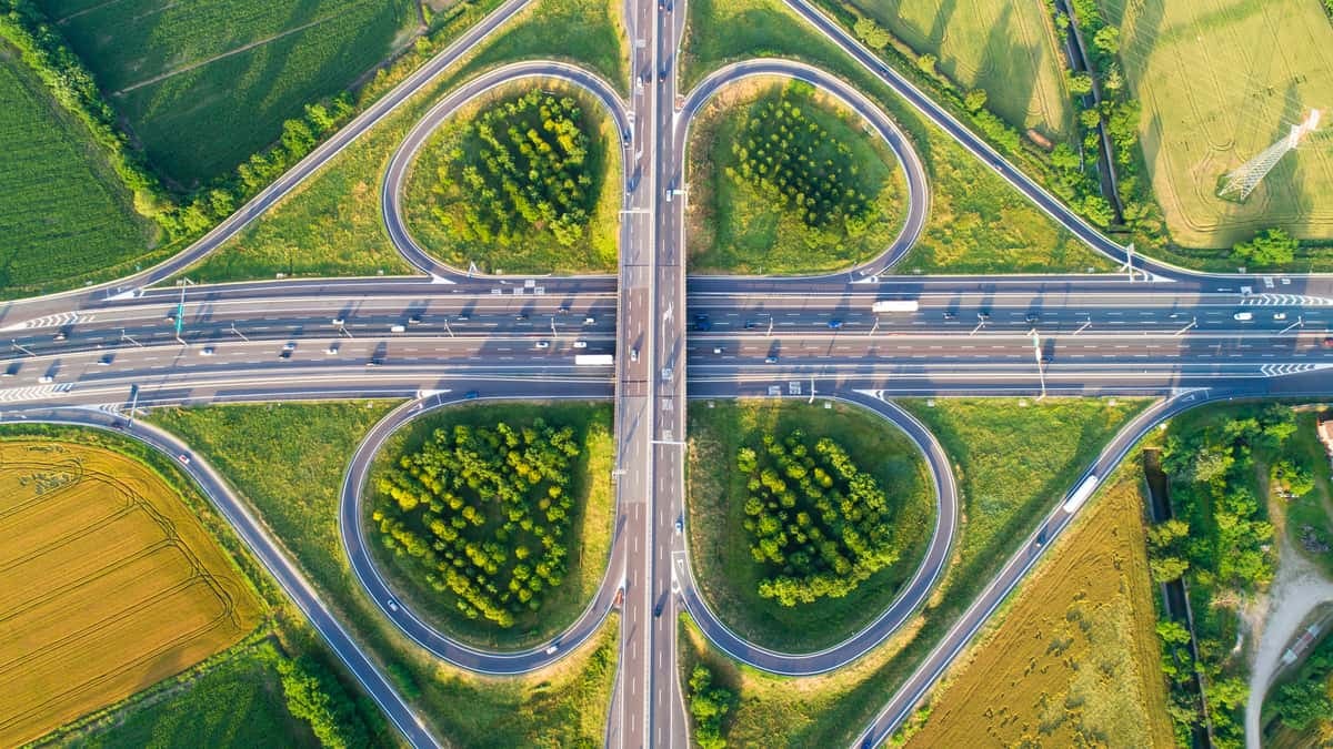 Rendering of a cloverleaf highway interchange with greenery.