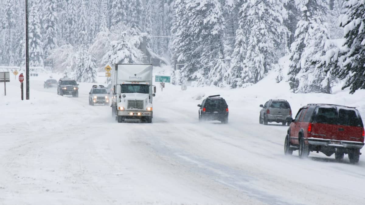 Cars and tractor-trailers on a snow covered Idaho highway.