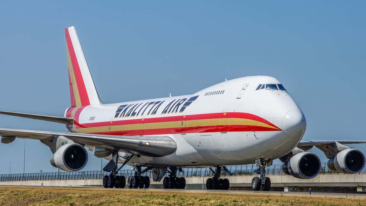 A white jumbo jet with burnt orange trim.