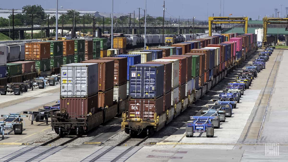 A photograph of intermodal containers parked at a rail yard.