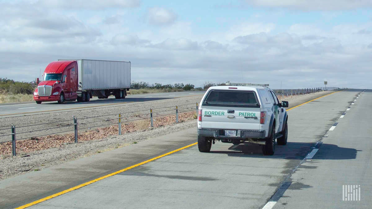 A truck and a border patrol vehicle pass near the U.S. Mexico Border. Cabotage regulations heavily restrict what trucks from Mexico and the Canada can do in the U.S.