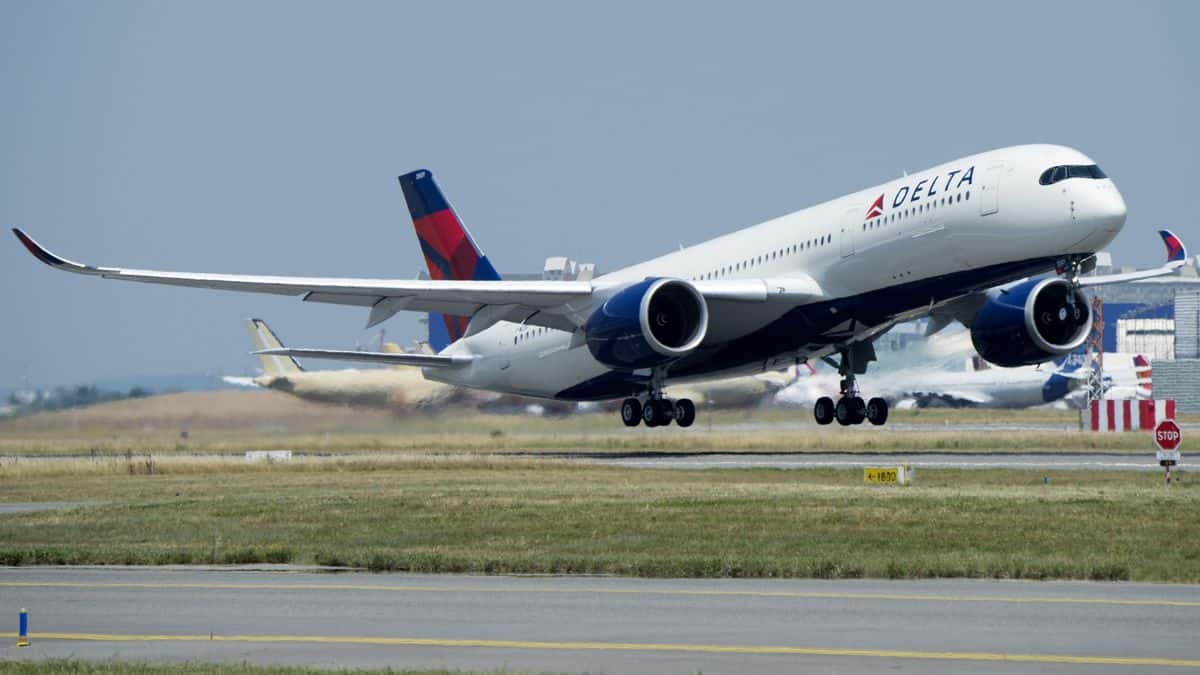 A white Delta jet takes off.