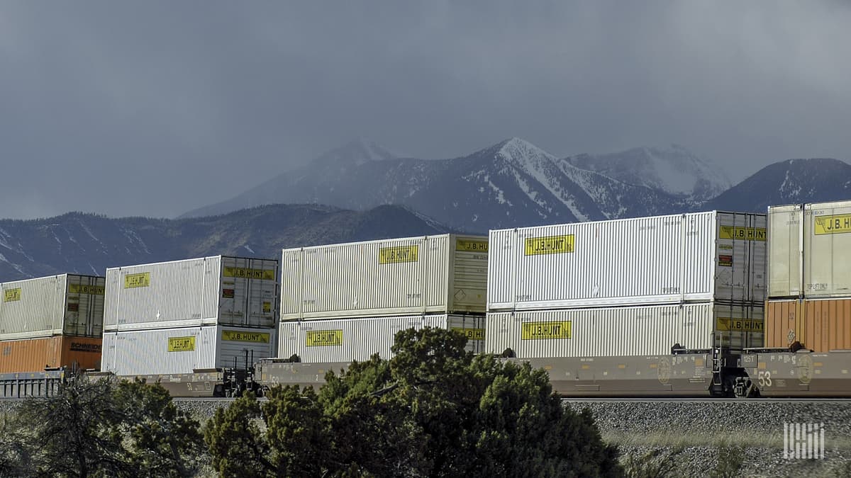 A photograph of a train hauling double stacked intermodal containers.