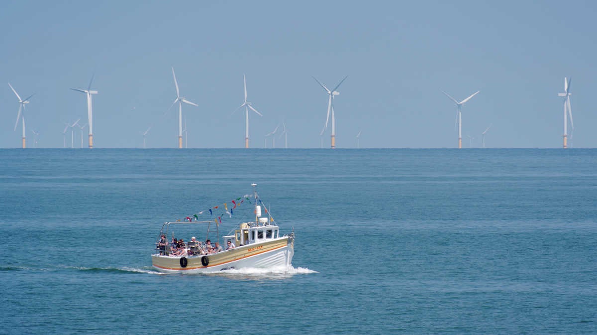 The Sea-Jay comes into dock at Llandudno, U.K., with the Ørsted Burbo Bank windfarm in the background.