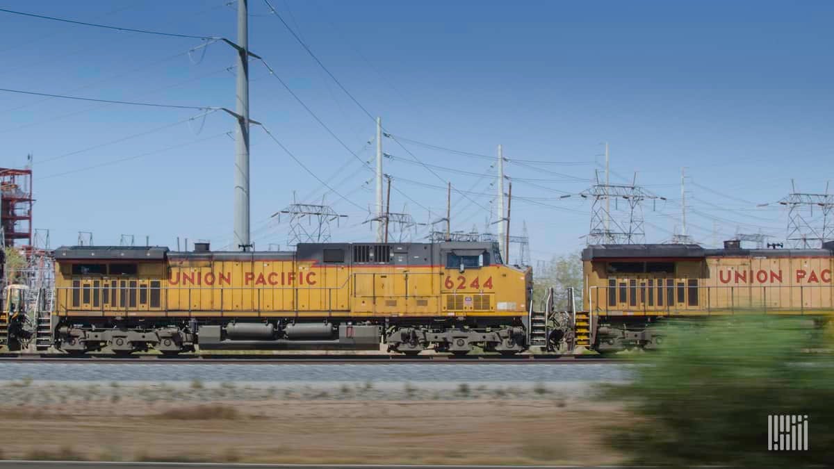 A photograph of two Union Pacific locomotives parked in a rail yard.