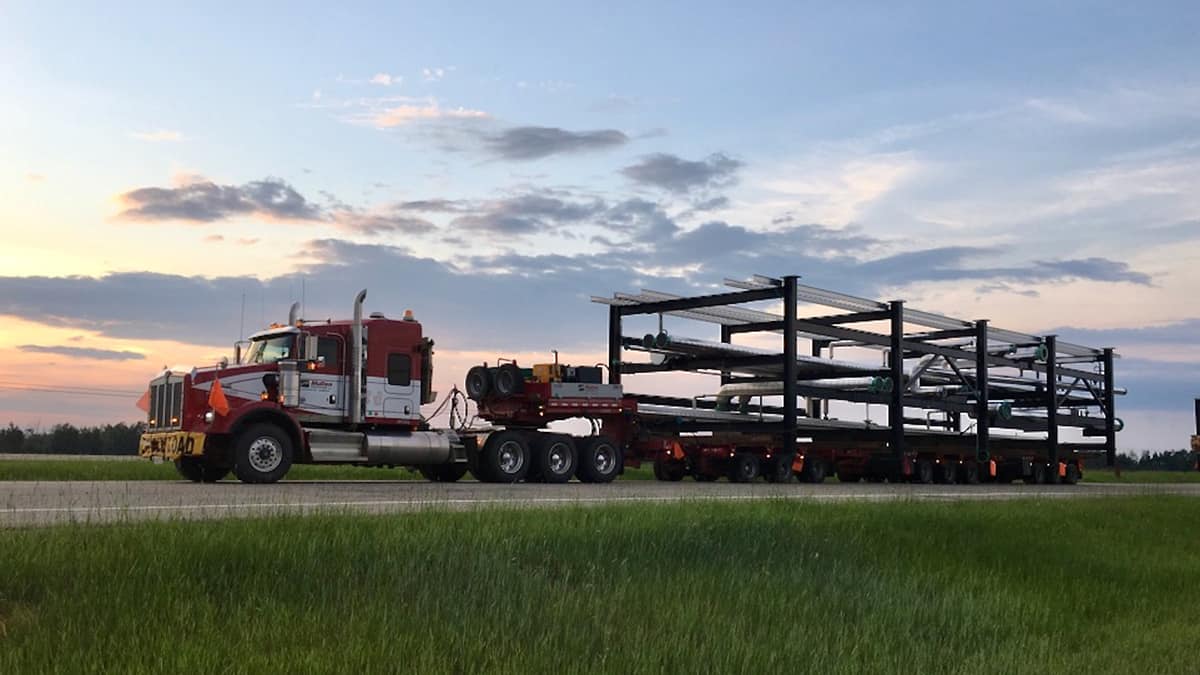 A tractor-trailer of a Mullen Group carrier during a sunset to illustrate an article about the company CEO's comments on the Canadian freight market.