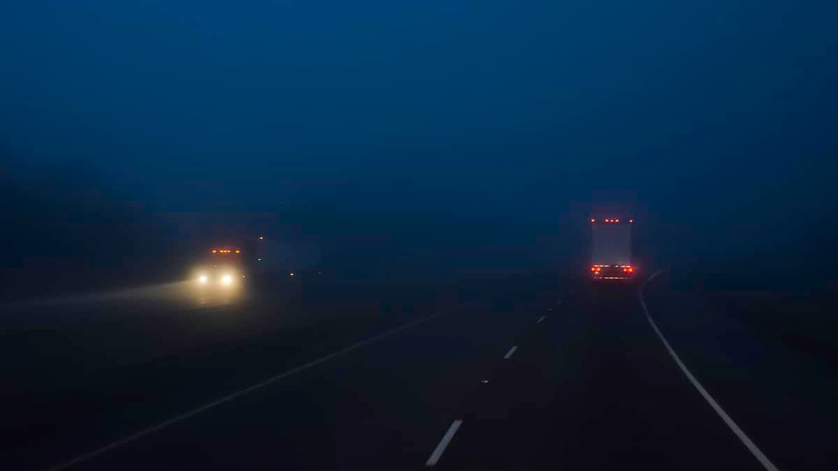 Two trucks passing during the night to illustrate an article about podcast episode about two truckers charged with kidnapping.