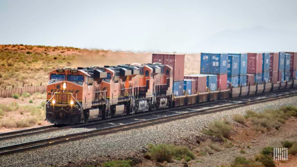 A photograph of a BNSF locomotive hauling intermodal containers across a desert.