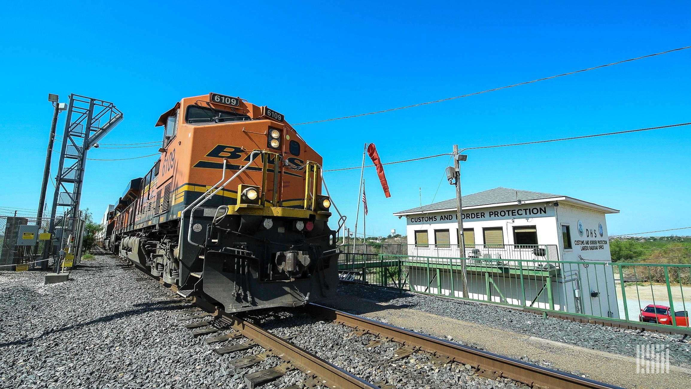 A photograph of a train by a CBP outpost.