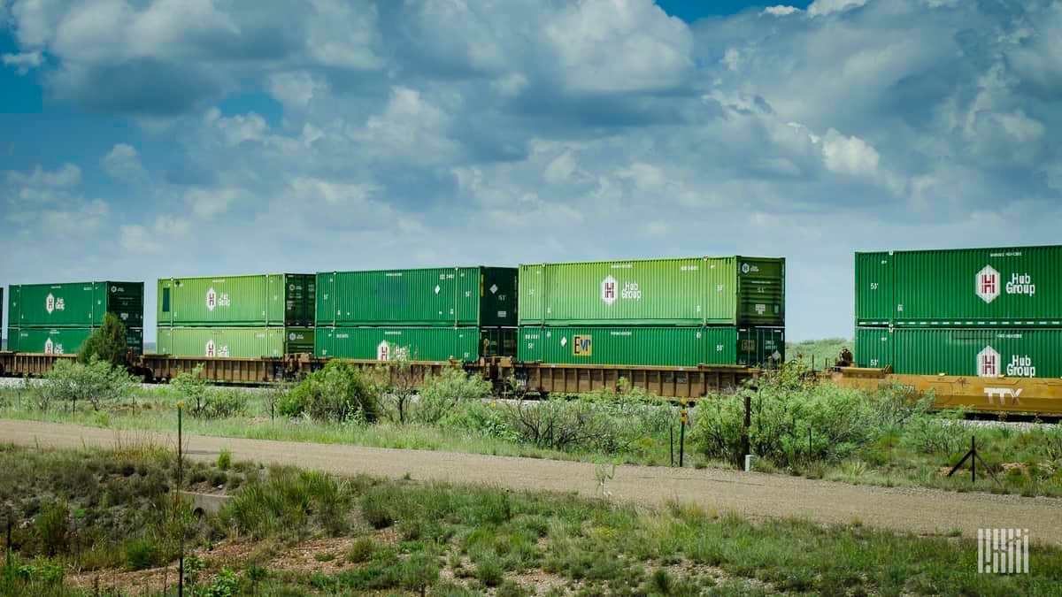 A photograph of intermodal containers double stacked on a train.