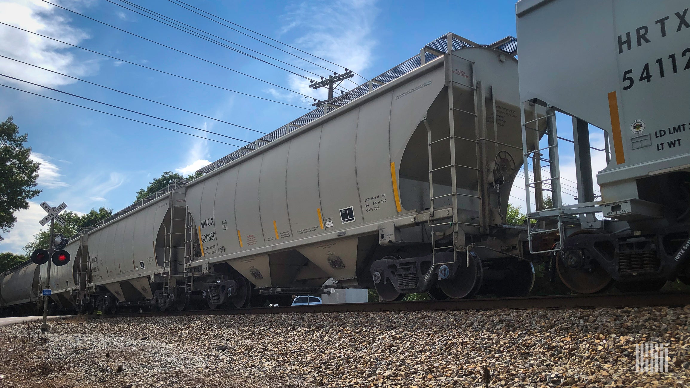 A photograph of hopper cars on a train.