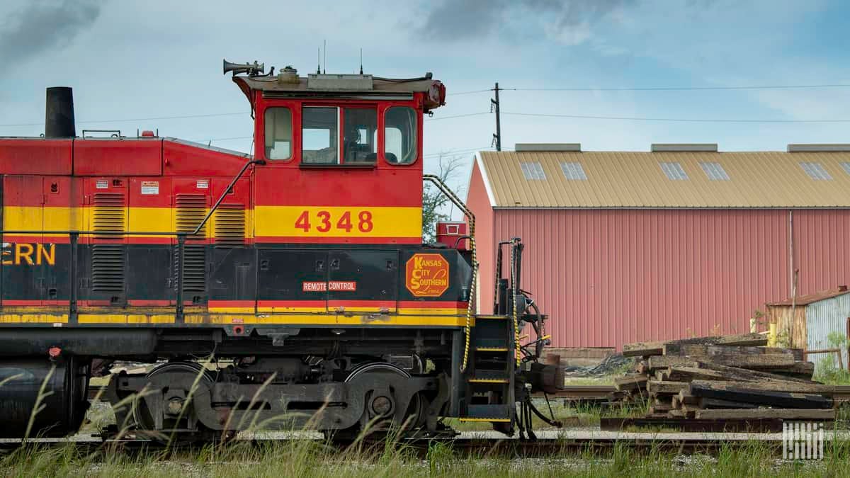 A photograph of a Kansas City Southern train in a rail yard.