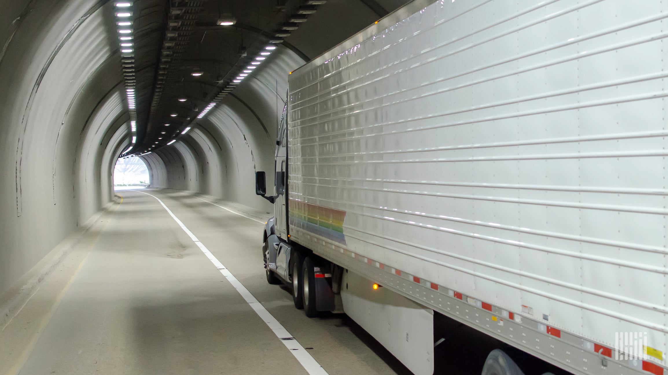 Tractor-trailer heading through a tunnel.