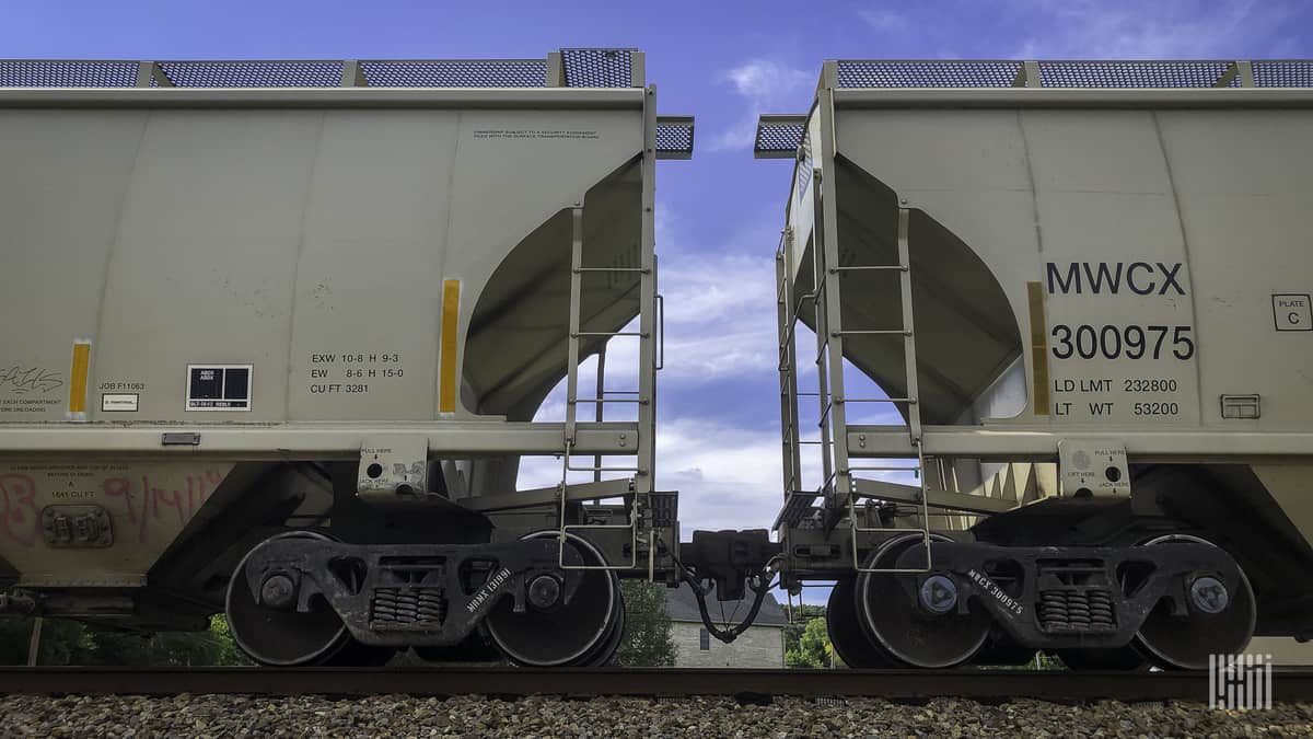 A photograph of hopper cars on a train track.