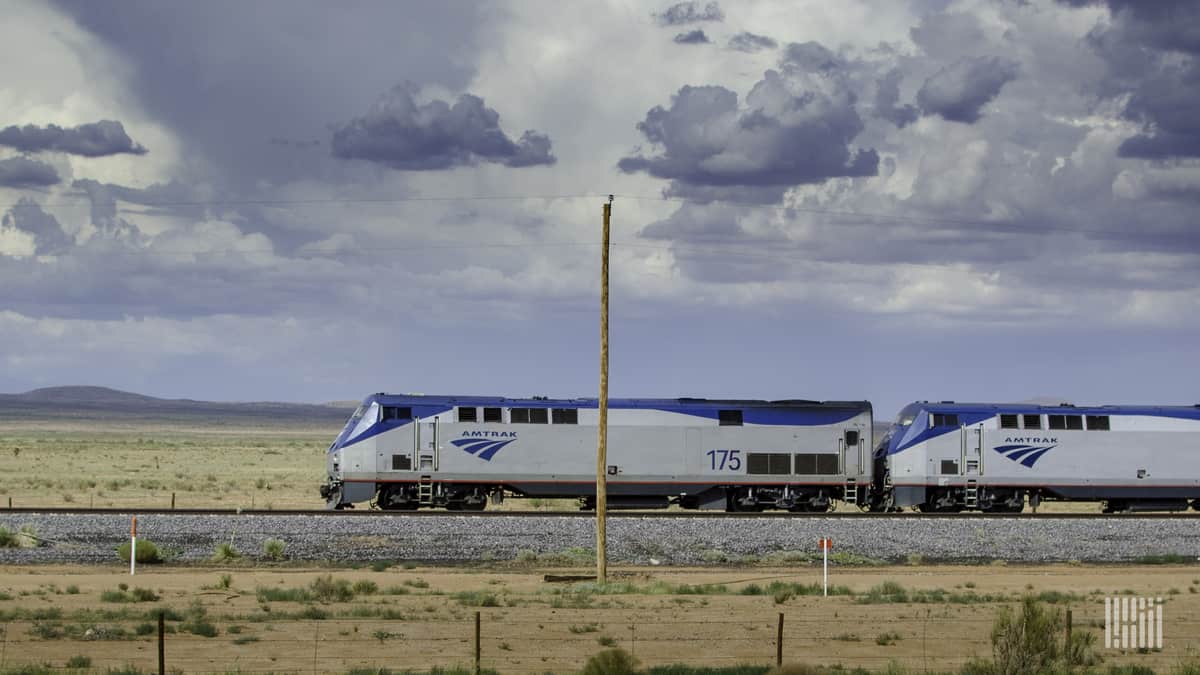 A photograph of an Amtrak train traveling through an open field.