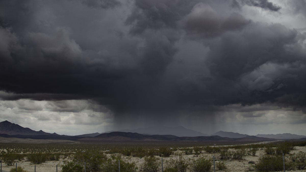 Thunderstorm moving across a highway.