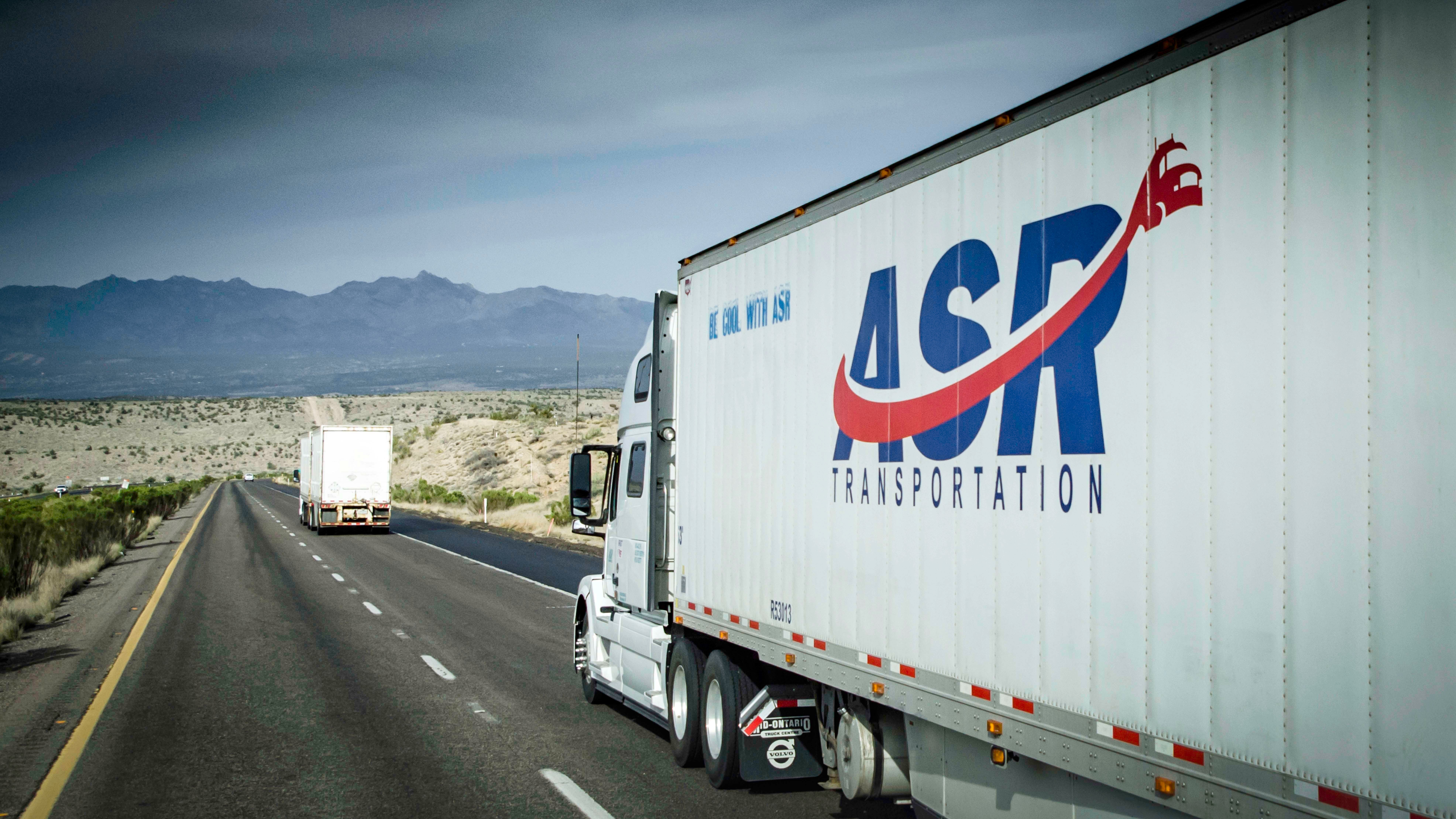 A tractor-trailer from ASR Transportation travels on a highway. The trucking company is part of legal dispute involving two brothers.