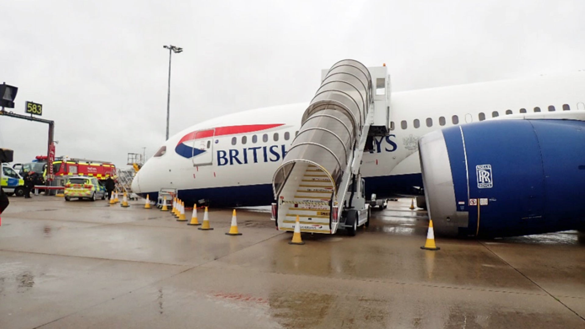 Side view of a British Airways airliner collapsed on its nose with stairs to cabin still attached.