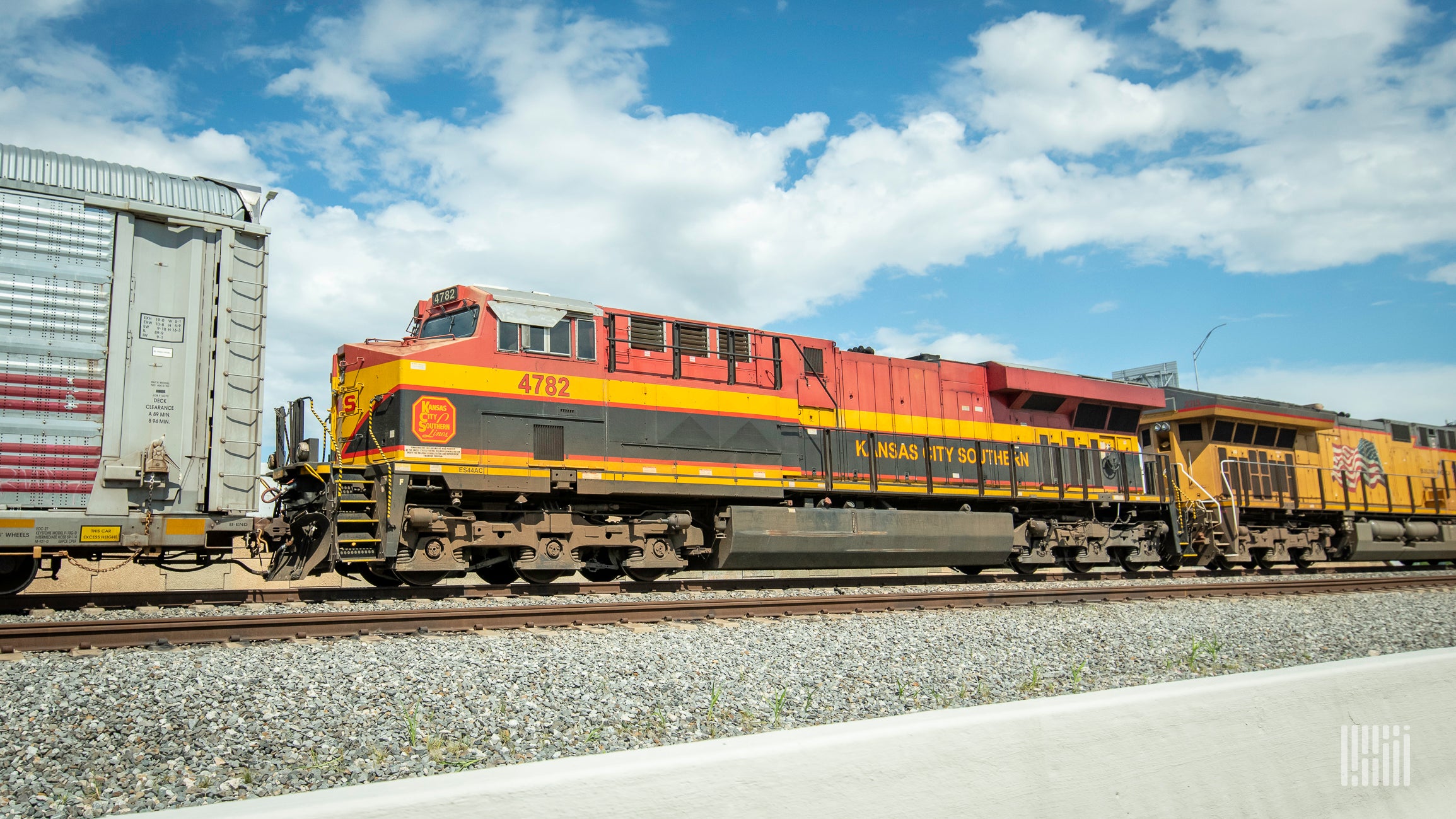 A photograph of a KCS train at a rail yard.