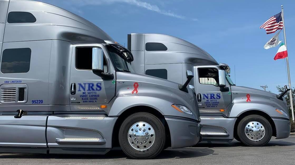 Side-by-side Nationwide Rail Services tractor-trailers.