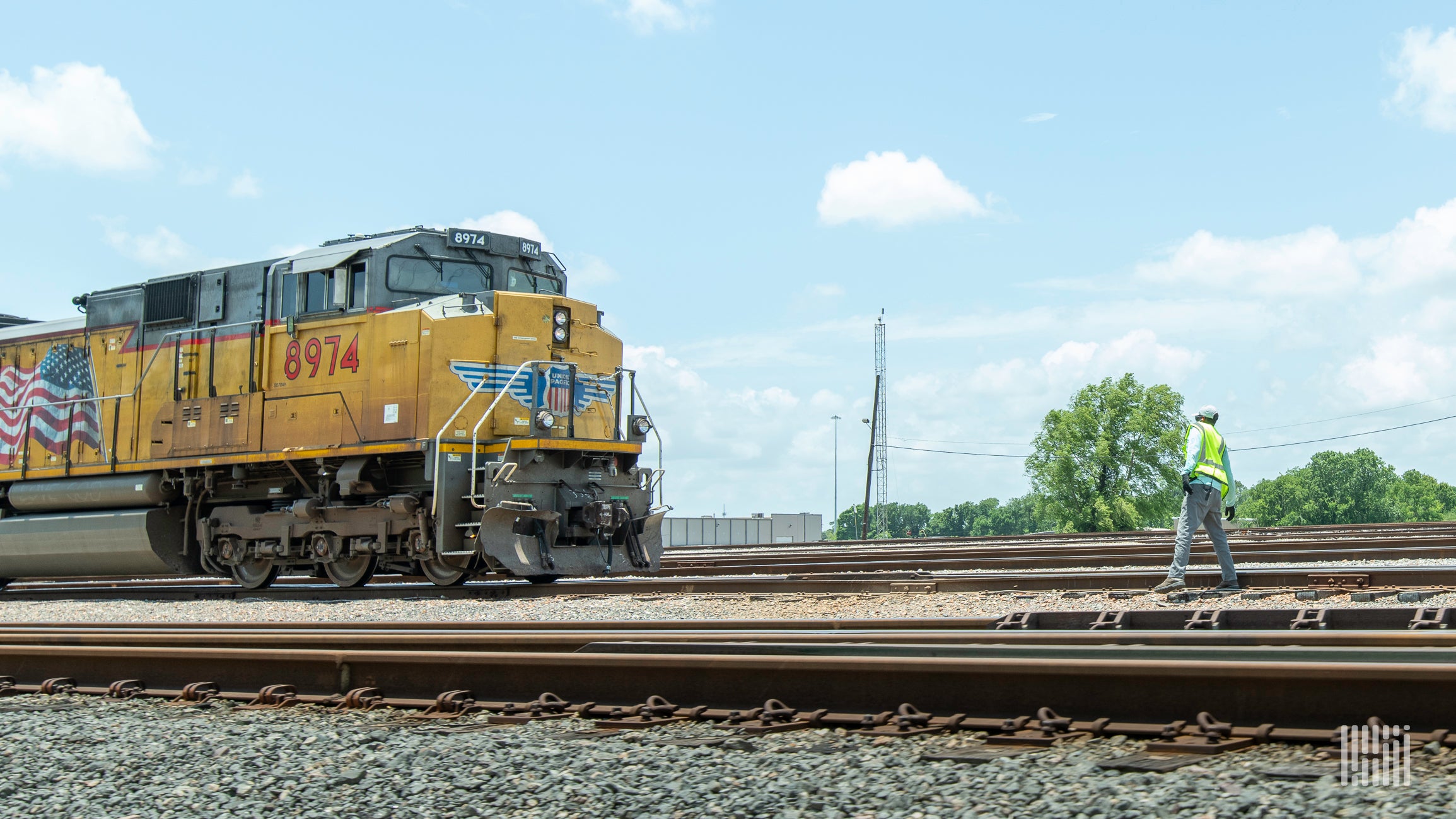 A photograph of a Union Pacific train on a train track.