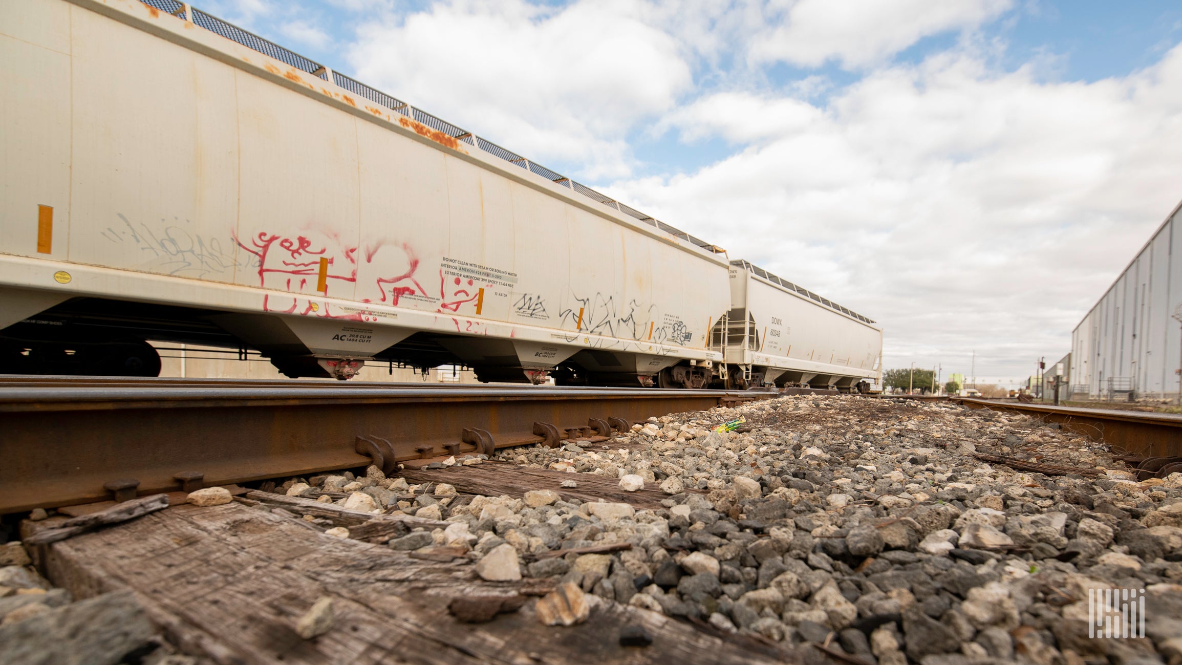 A photograph of trains of hopper cars sitting in a rail yard.