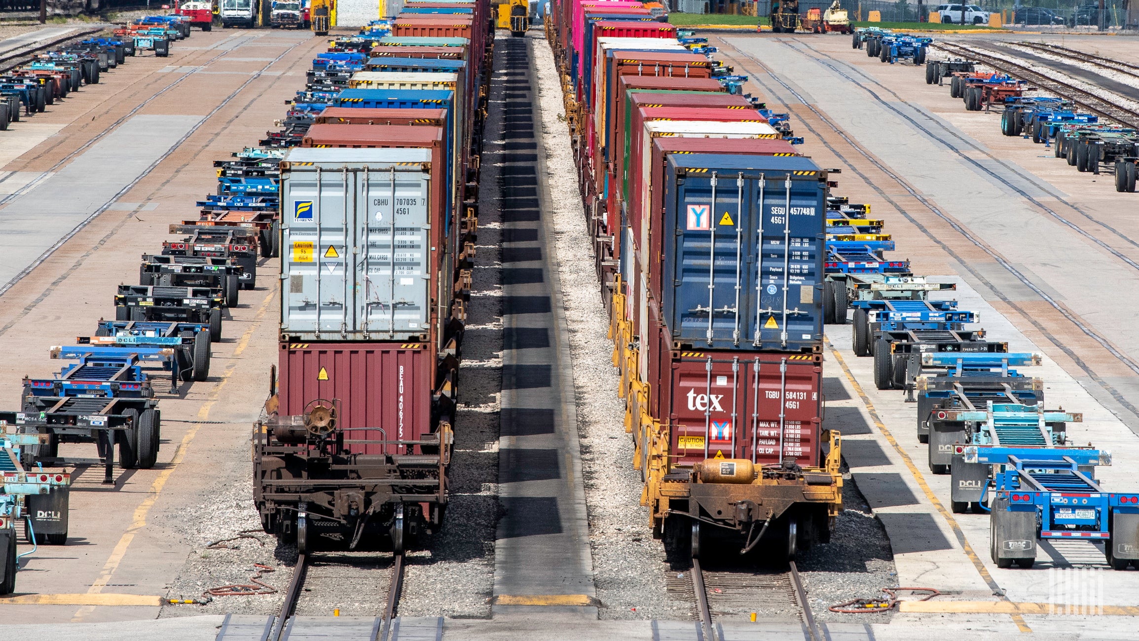 A photograph of containers parked in a rail yard.