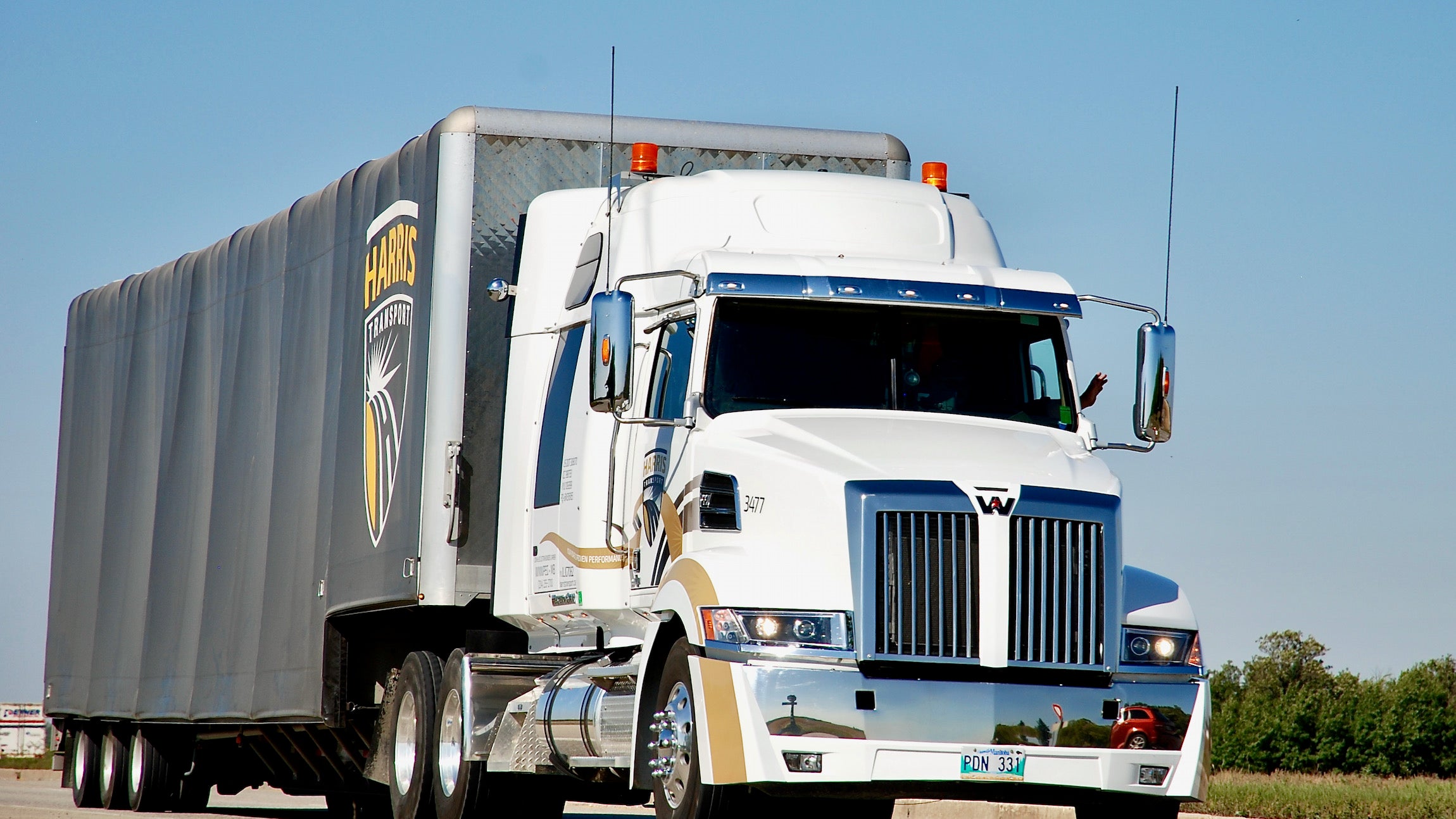 A white-tractor trailer of Harris Transport, a company recently bought by Mullen Group