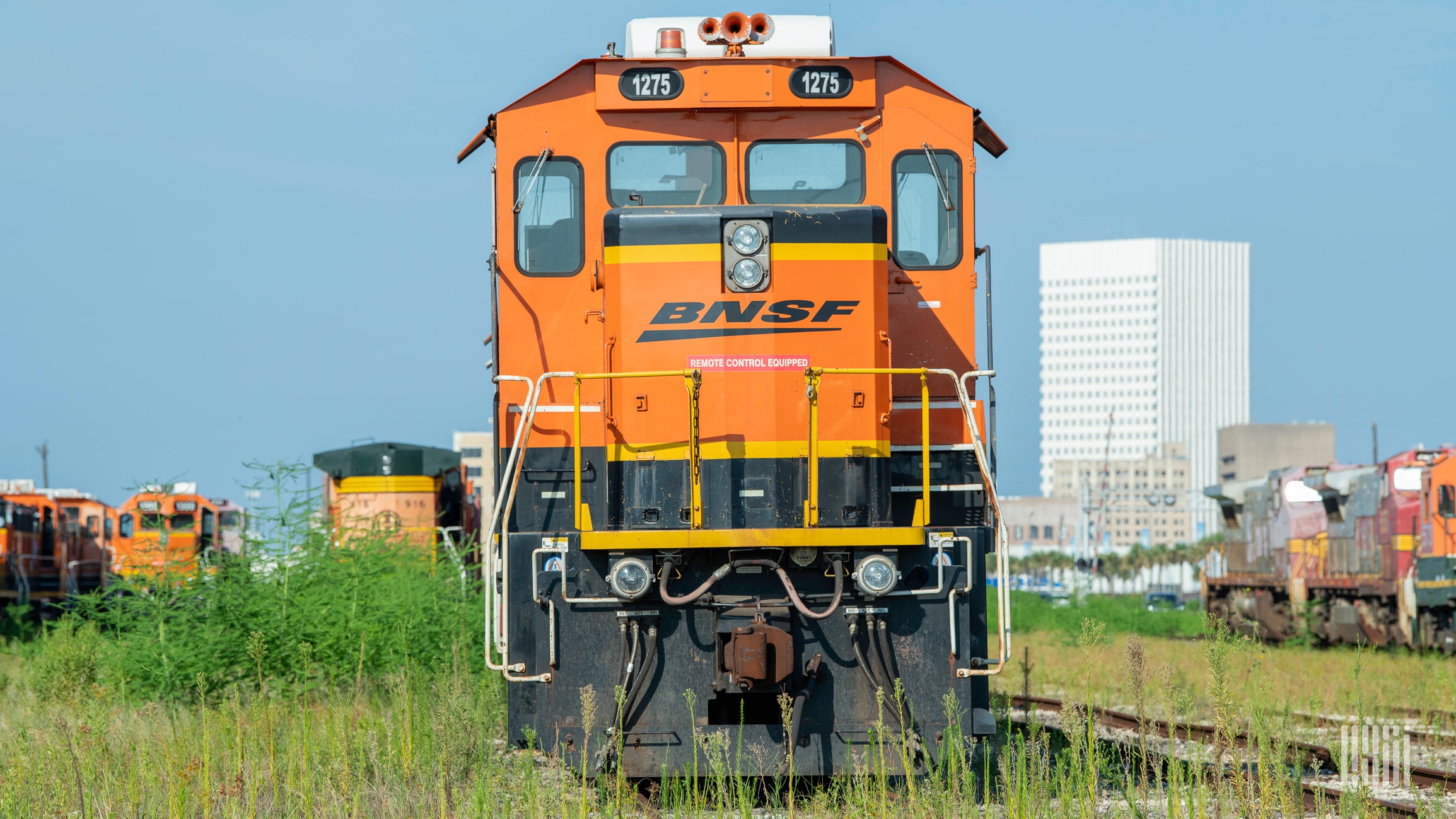 A photograph of a BNSF locomotive in a rail yard.