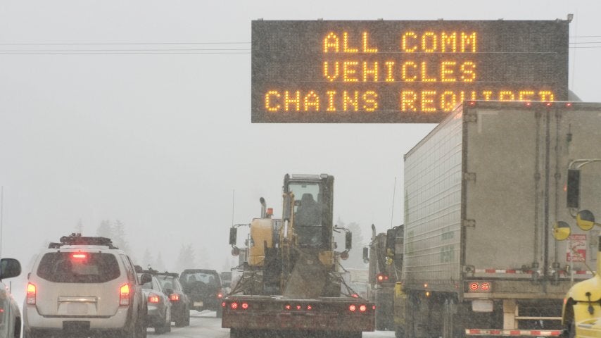 "Chains required" sign on a snowy Colorado highway.